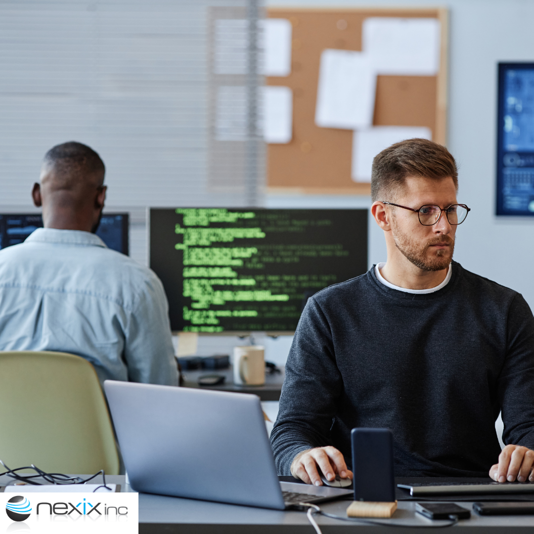 2 men working on computers coding