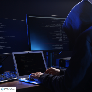 A hacker working on multiple screens