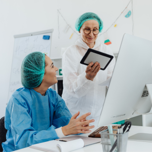 Two medical professionals looking at a tablet