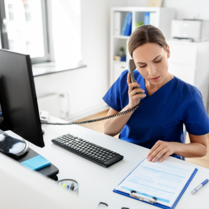 Hospital worker on the phone at a desk