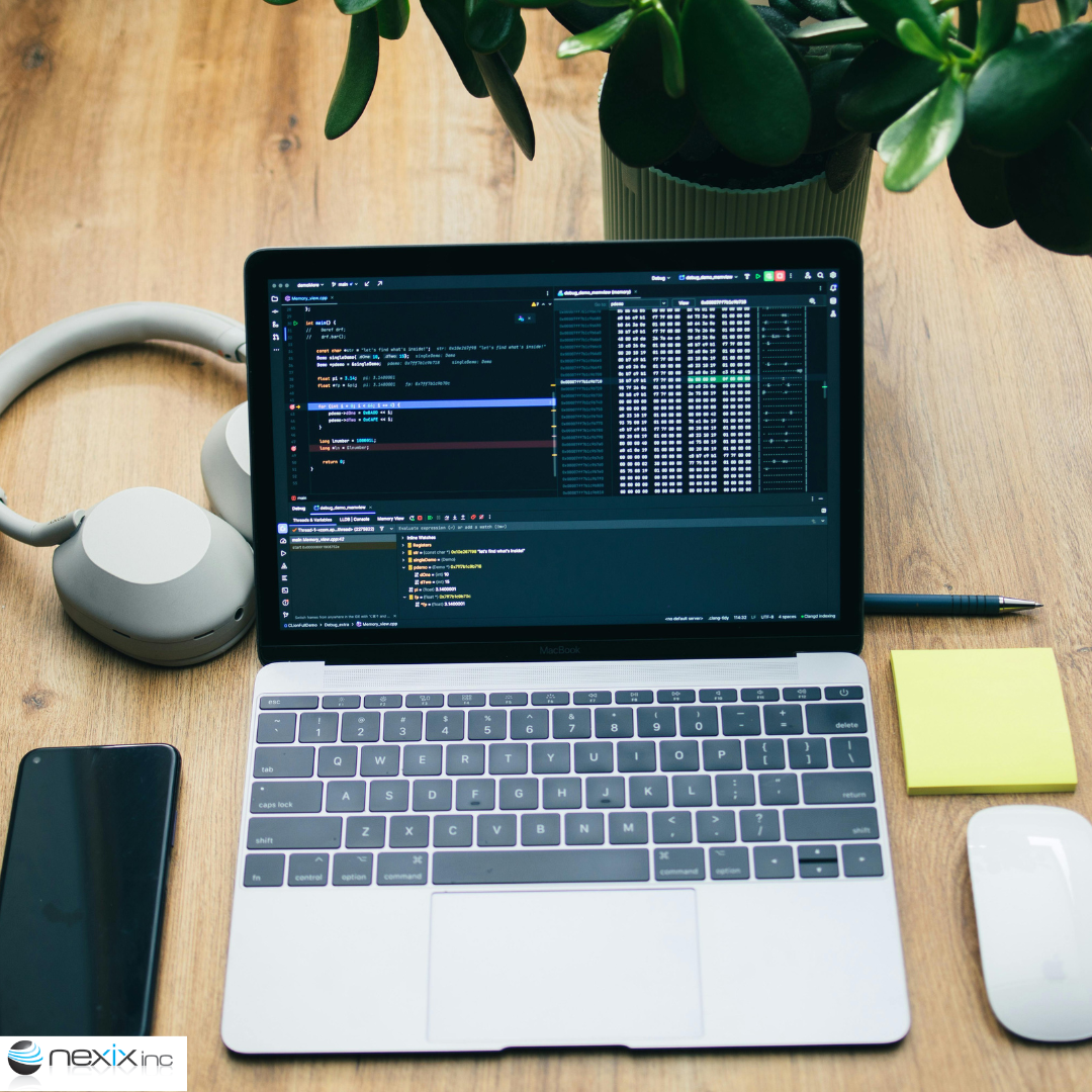 A laptop, headphones, a phone and mouse on a table