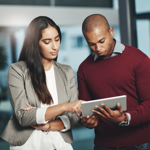 A woman and a man looking at a tablet 