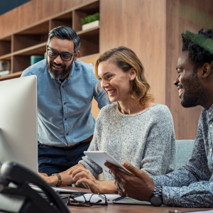 2 men and 1 woman looking at a computer